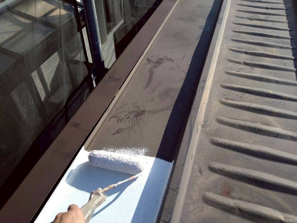 仙台市青葉区で金属屋根の大屋根に日本ペイント塩ビゾルウレタンプライマーを施工している様子